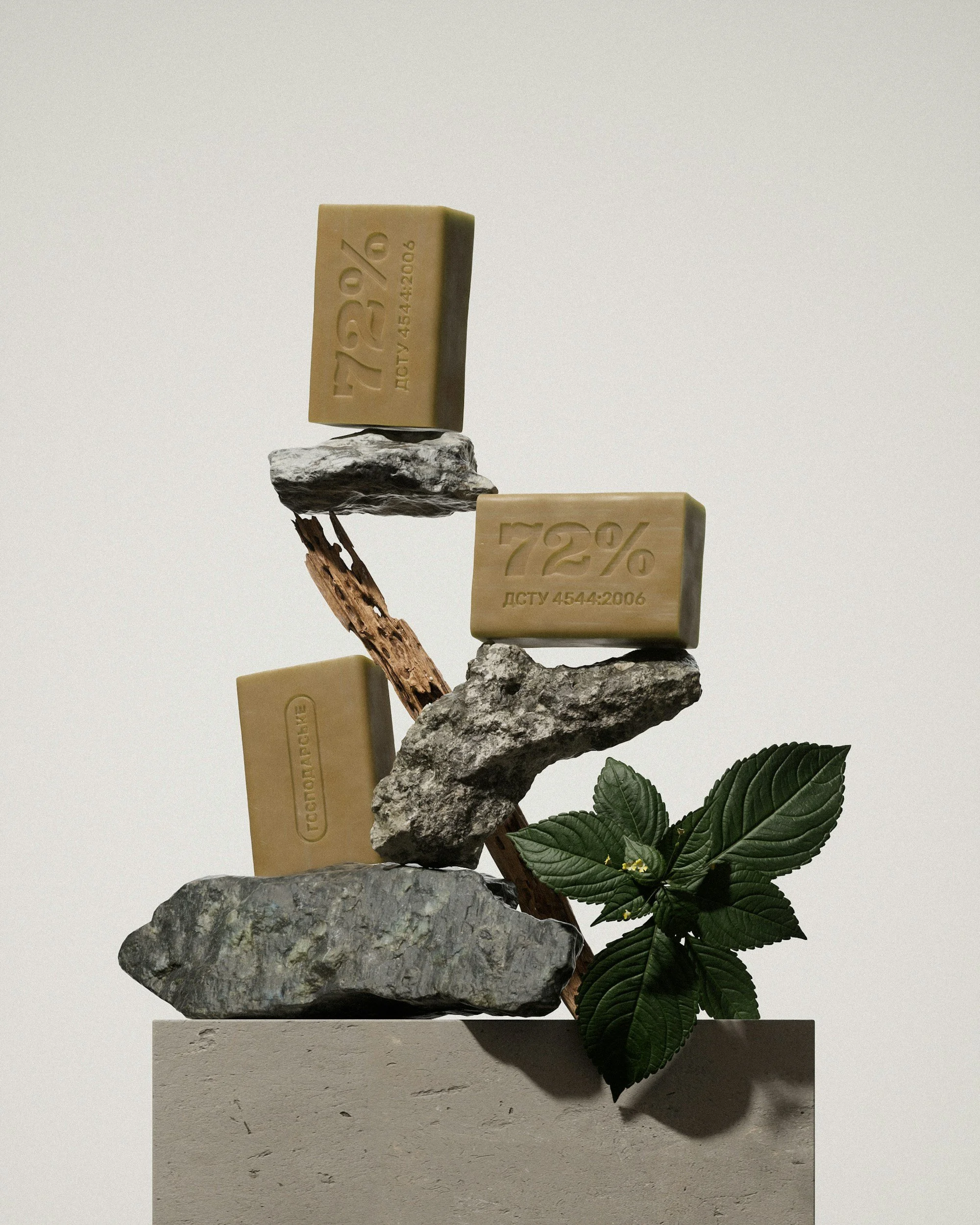 Multiple bars of soap stacked on rocks and branches, with green leaves at the bottom right. The soap bars have embossed text and appear natural and organic.
