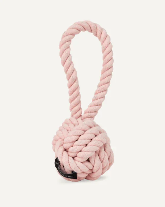 A pink plush rope dog toy with a knotted ball and loop handle.