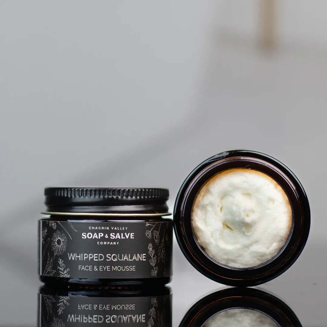 Whipped squalane face and eye cream in glass jar with airy texture