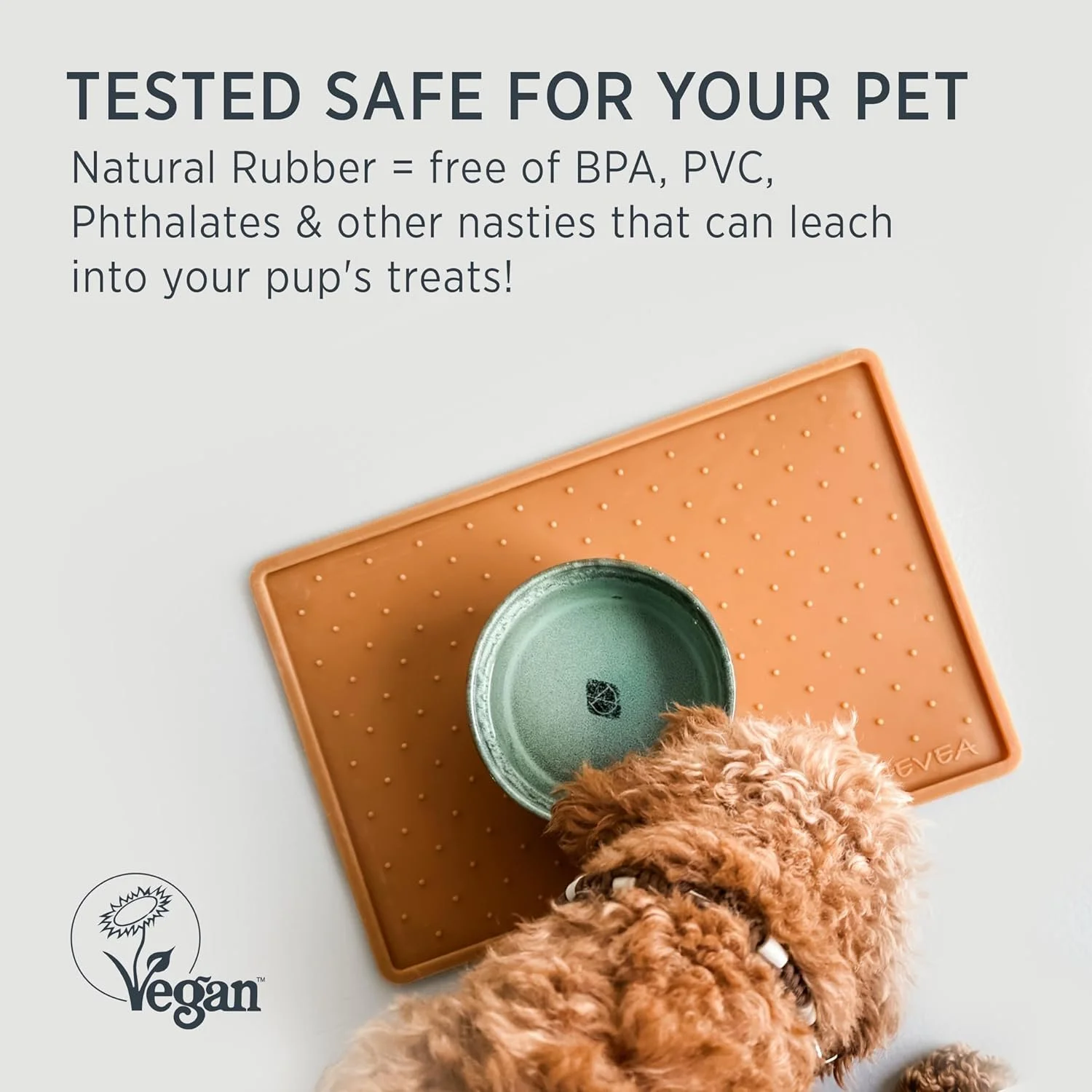 Dog eating from bowl on natural rubber mat