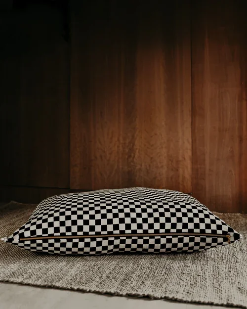 Black and white check dog bed with removable washable cover and recycled fill insert