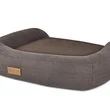 A dark gray pet bed with raised edges and a small leather tag on the side.
