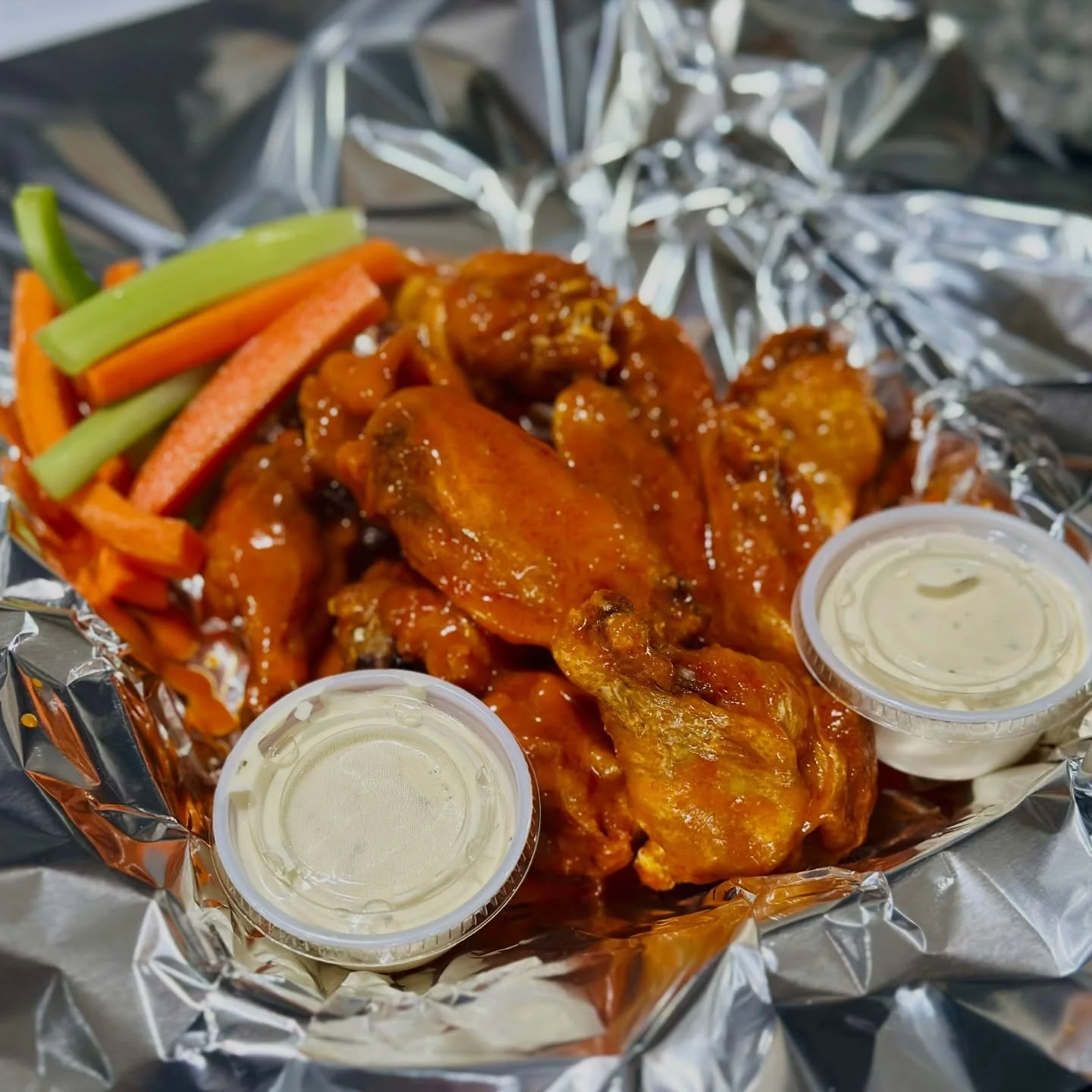 Our bone-in wings &mdash; tossed in bold flavor, served hot, and built to satisfy.

Crispy outside, juicy inside, and paired with your choice of dip - Classic Bleu Cheese or Ranch.

🍗 Bone-in wings
🔥 Big flavor, every bite
🥕 Served with fresh vegg