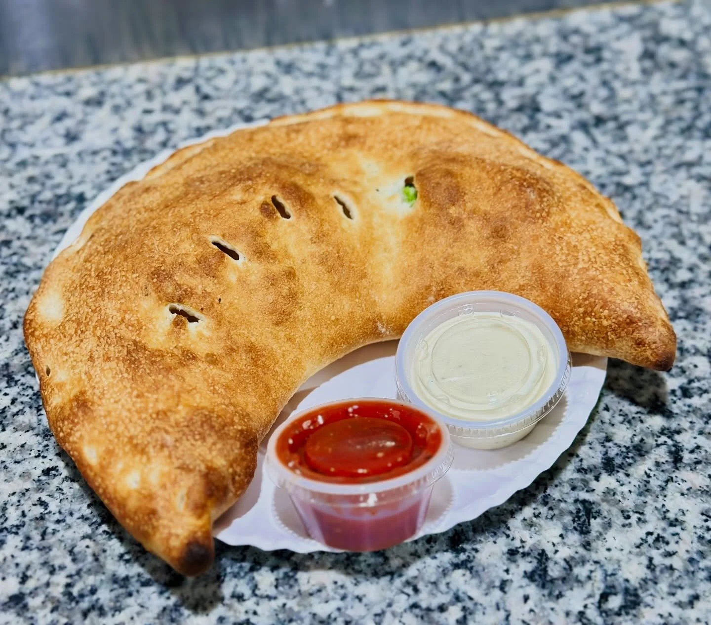 Our broccoli &amp; ricotta calzone &mdash; loaded, golden, and nearly half a medium pizza folded into one.

Crispy on the outside, creamy and packed with flavor inside.

🥦 Broccoli + ricotta filling
🧀 Melted, rich, satisfying
🍕 Basically a pizza&h