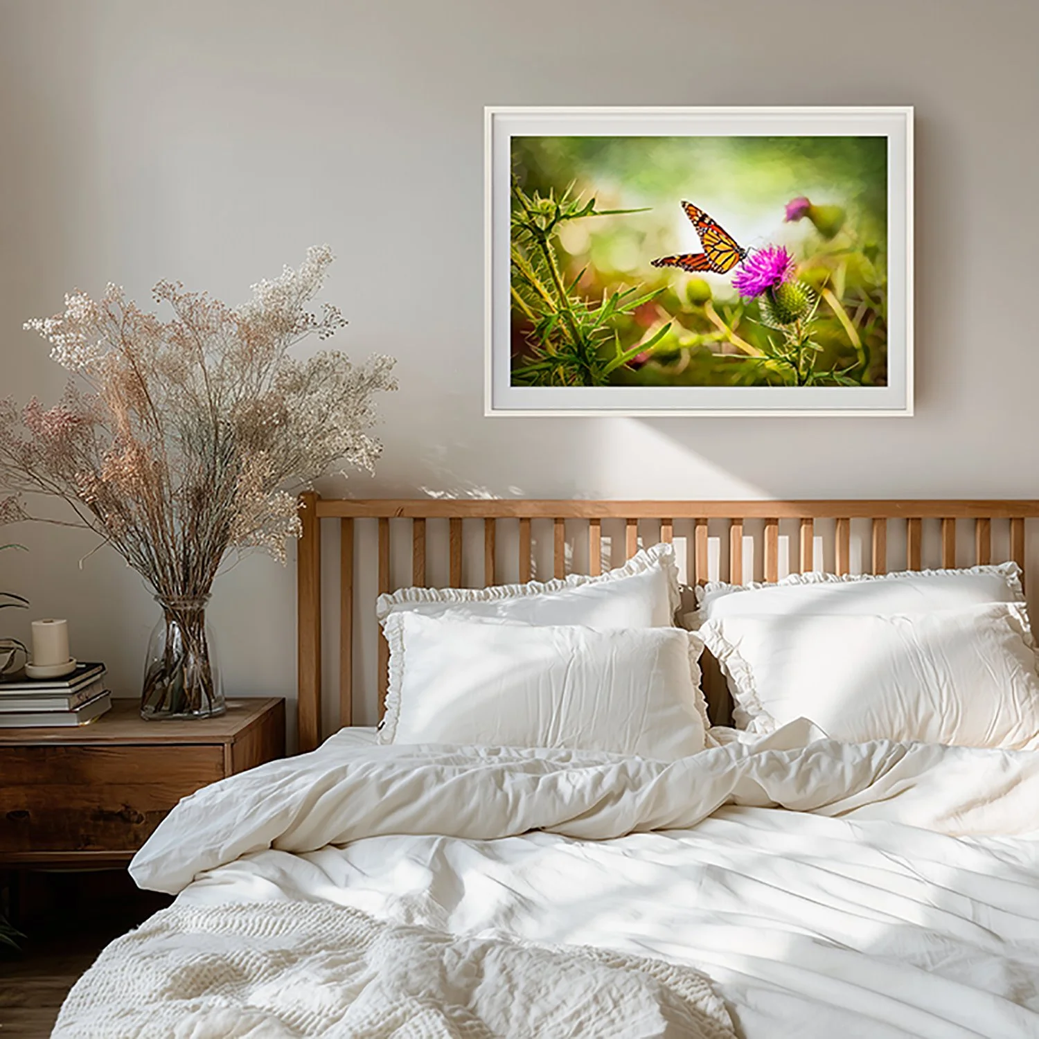 Made for Each Other by Laura Berman — monarch butterfly on thistle fine art print above a wooden bed with white linens and dried grasses