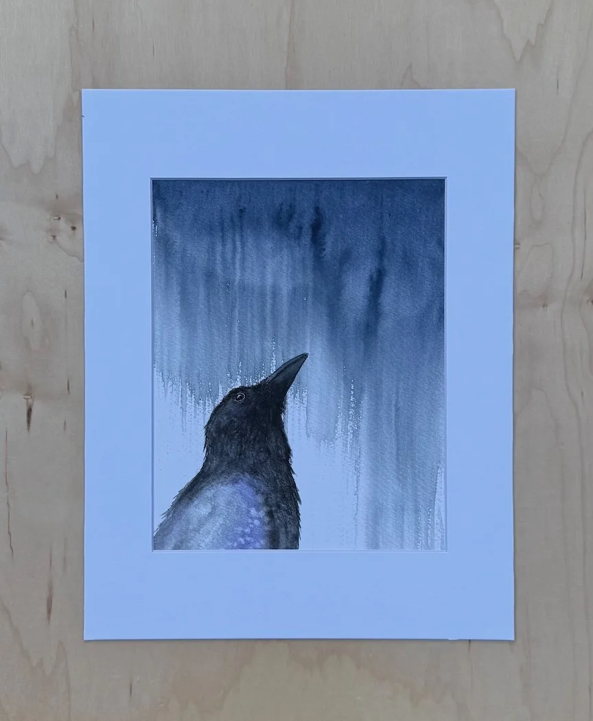 Archival watercolor print of a crow in the rain, painted in soft blue-gray washes, matted to 11 × 14 inches and reproduced from the original painting by artist Monica Adams.