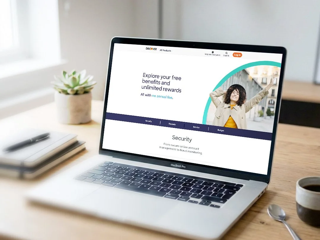 Image of laptop on a wooden office desk, image of a website on the screen