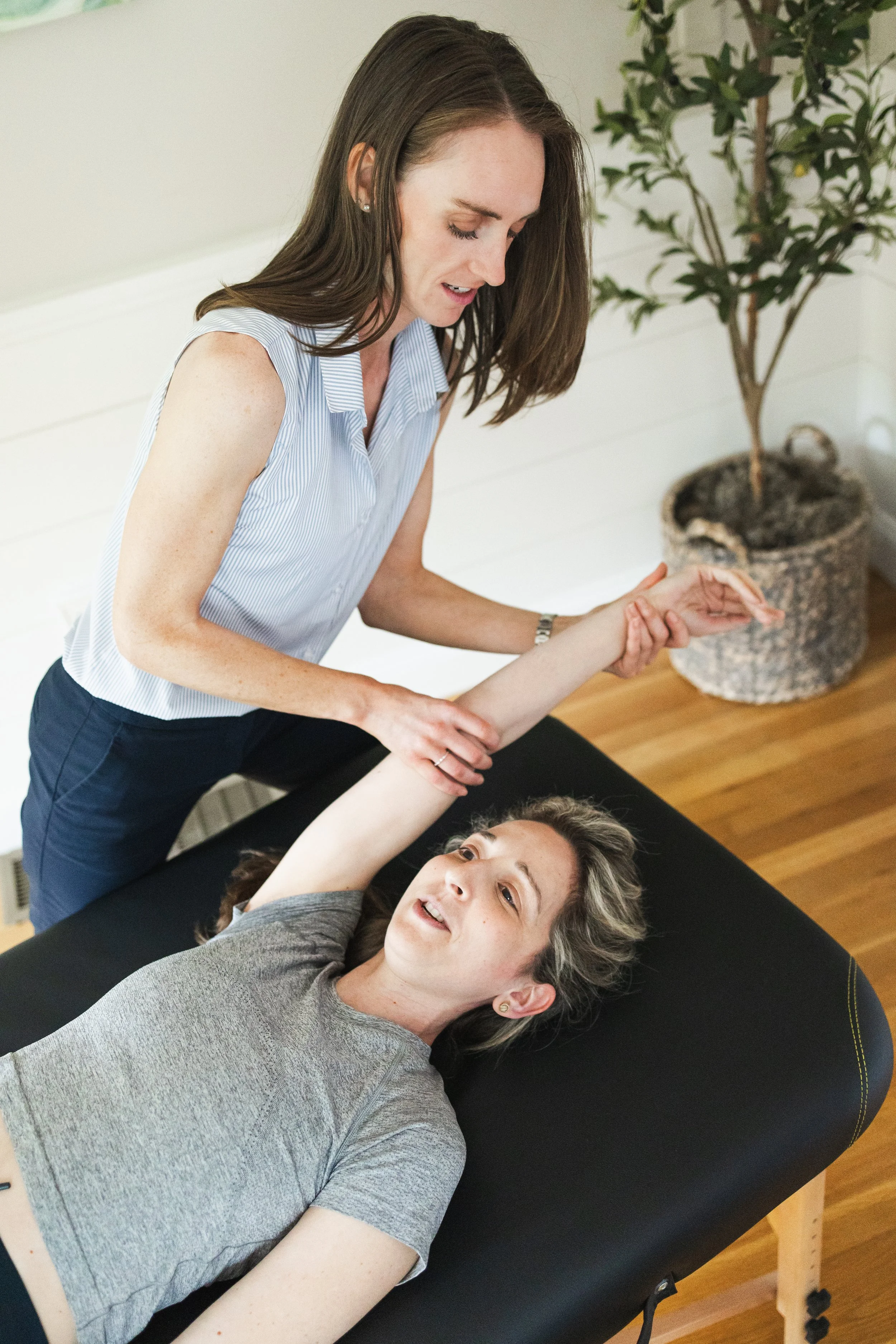 Dr. Julia Cross guiding a patient through an assisted stretch.