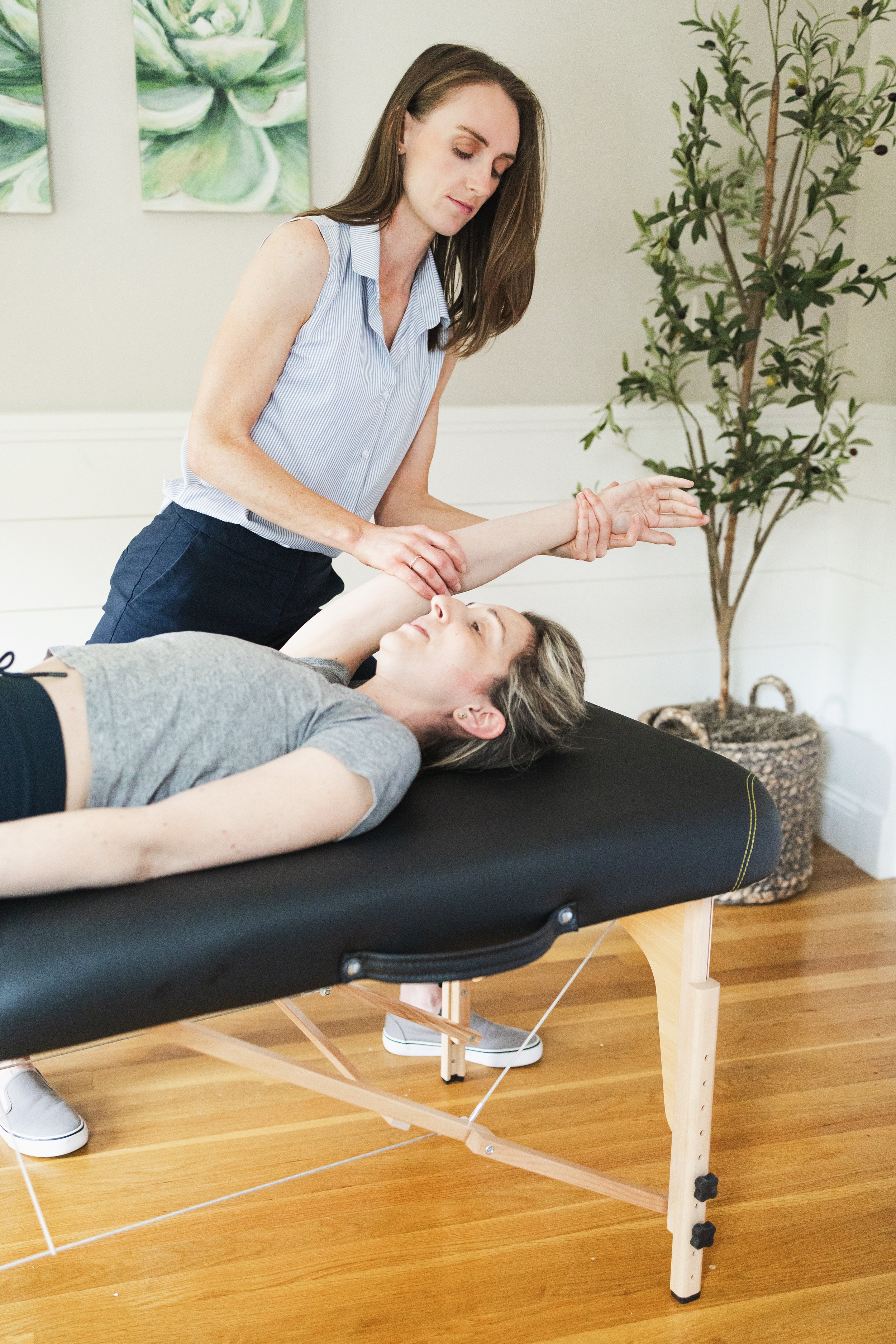 Julia Cross, Licensed Physical Therapist supporting a physical therapy client in South Shore area office.