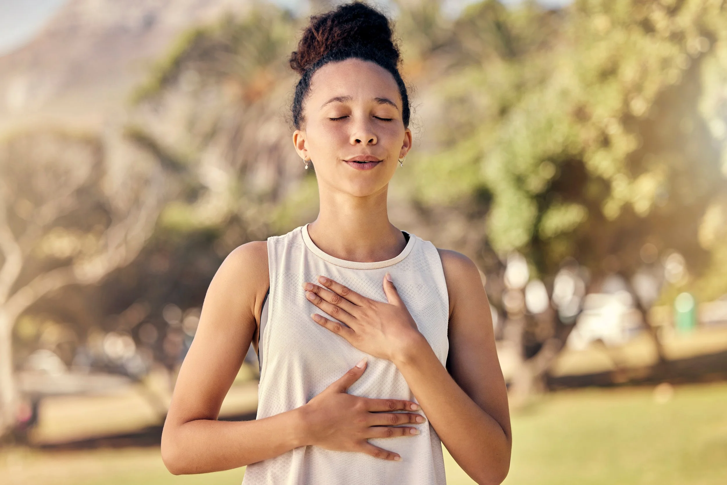 A woman engaging in breathwork practice focused on building a foundation for movement, core stability, and pressure management.