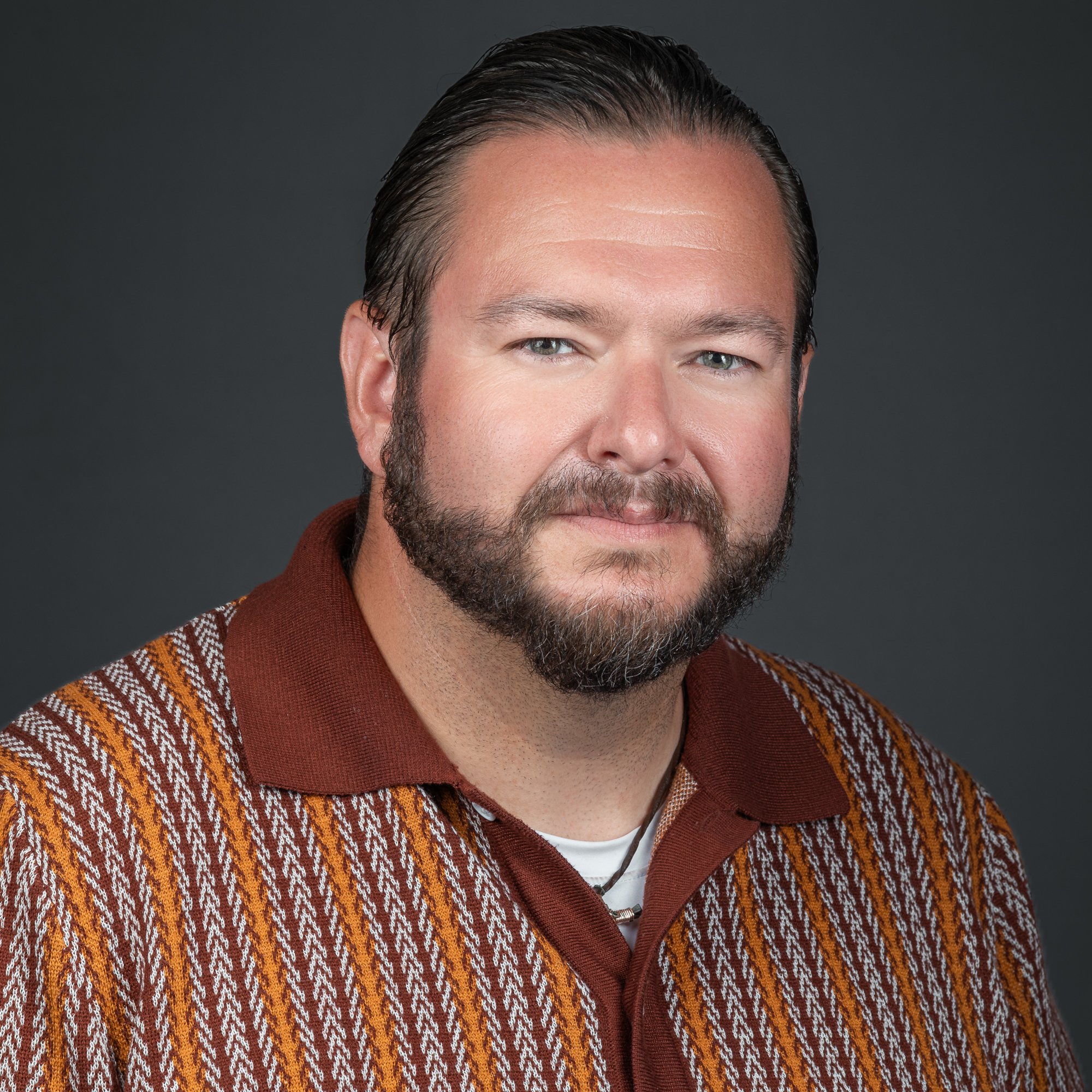 Bearded man in patterned sweater smiling for corporate headshot – Western Slope photographer