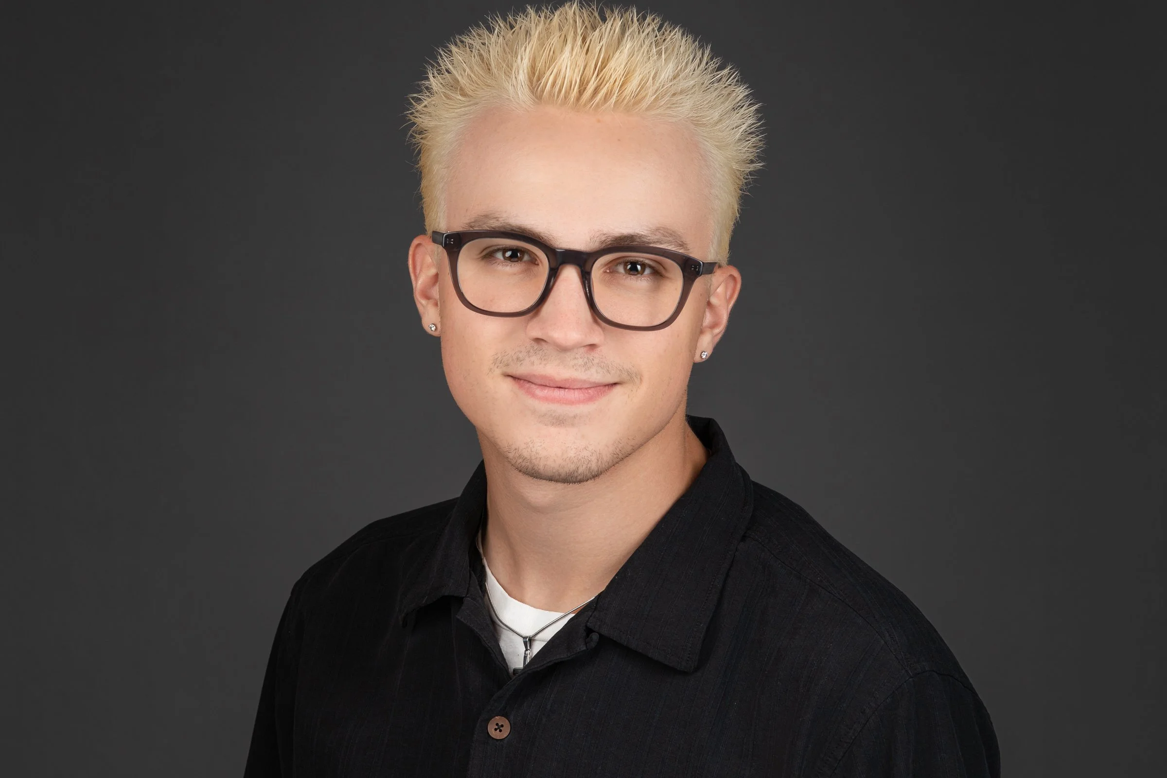 Young man with blonde hair and glasses in professional headshot session – Grand Junction CO