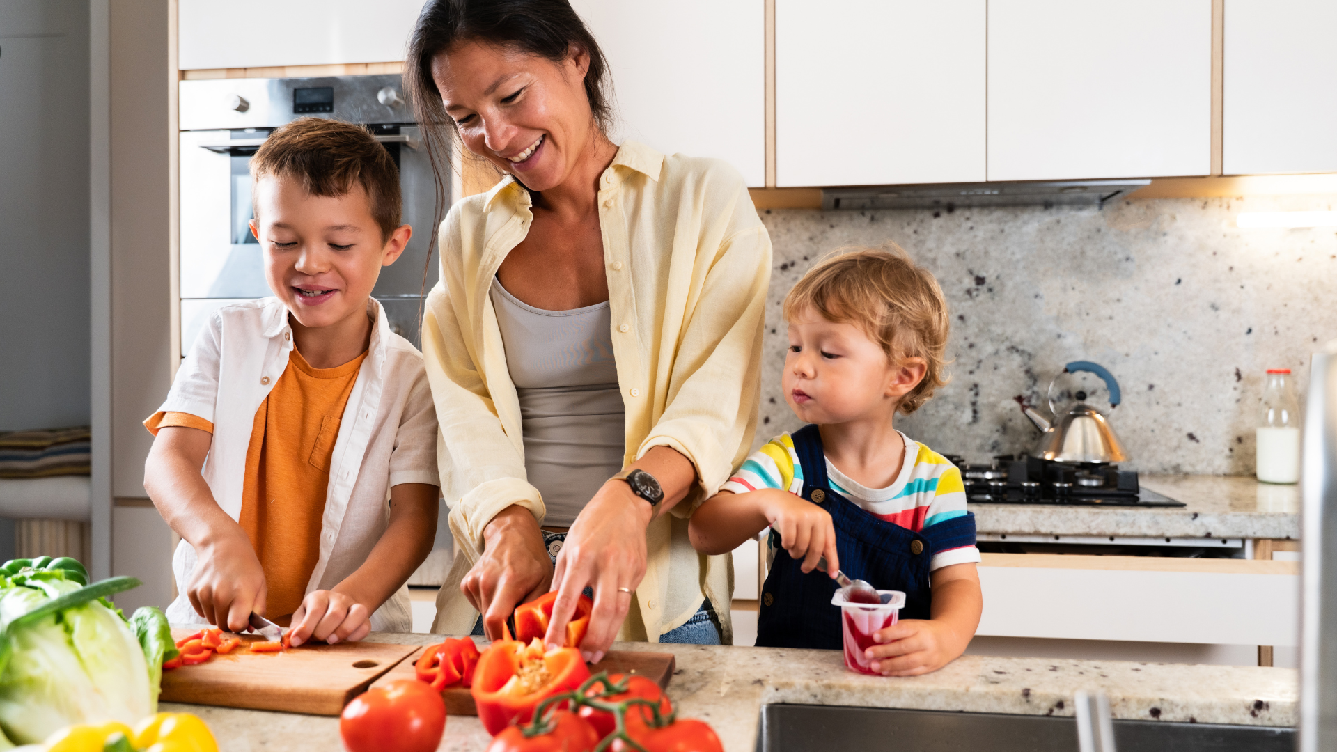 Mom and kids cooking in a comfortable kitchen kept just right by AC service and heating from Climate Express Heating & Air in New Braunfels, TX