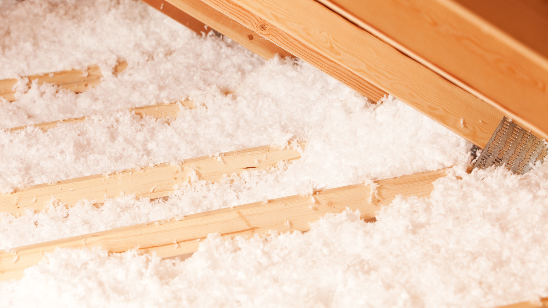 Blown in insulation for attic being installed by Climate Express Heating & Air in New Braunfels, Texas