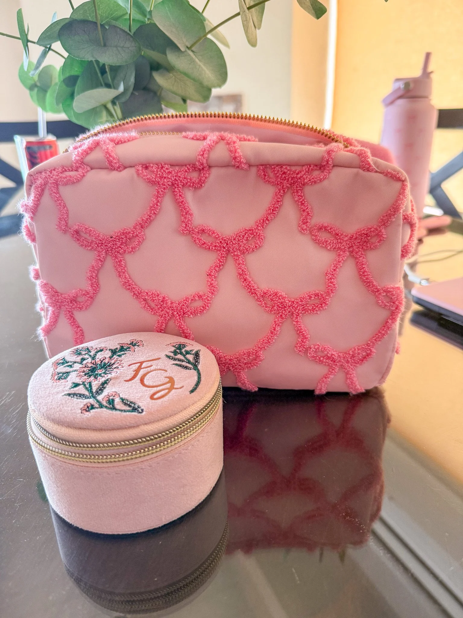 A pink jewelry case and pink toiletries bag.