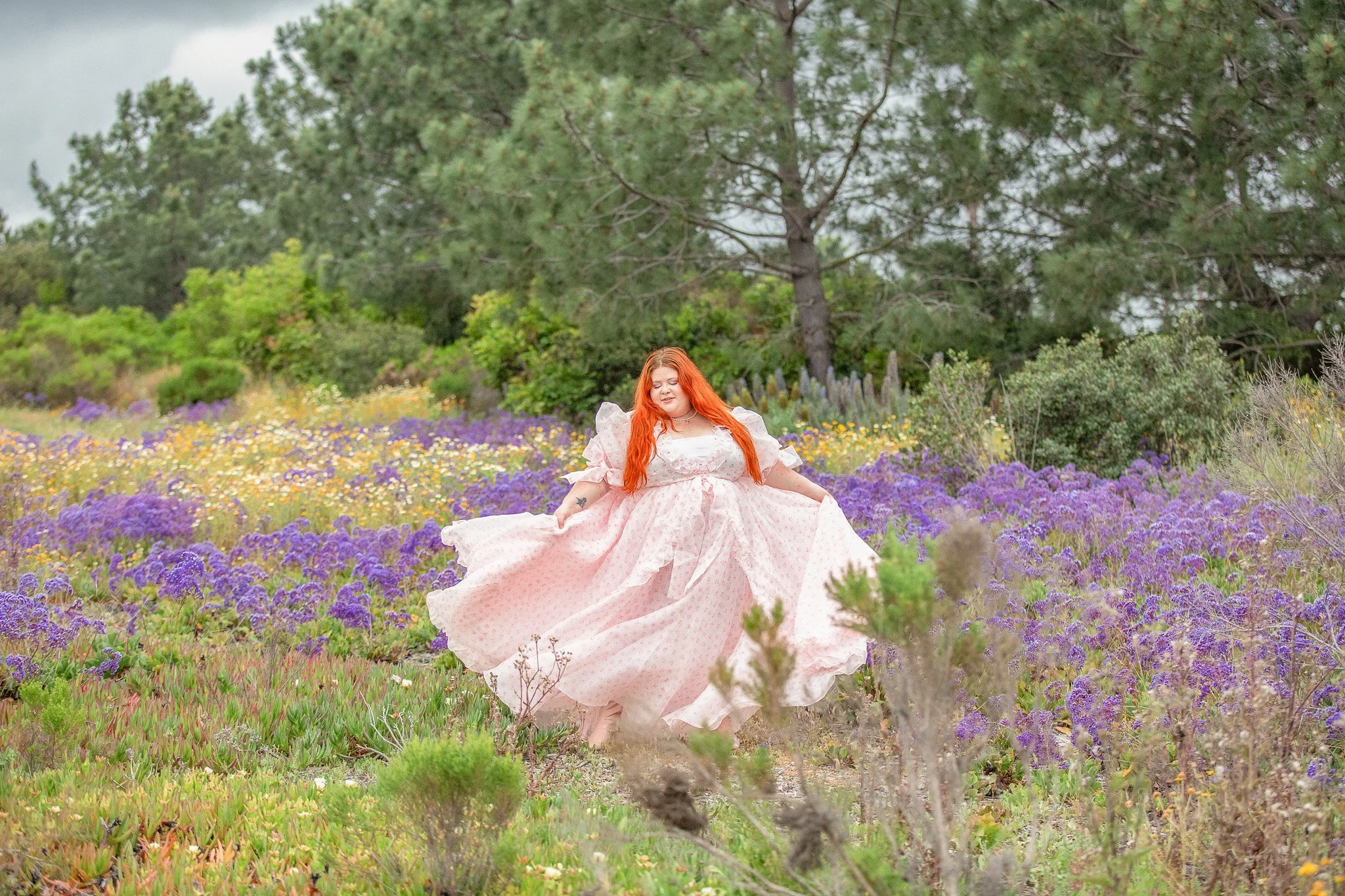 Plus size woman in a flower field wearing a plus size Selkie dress