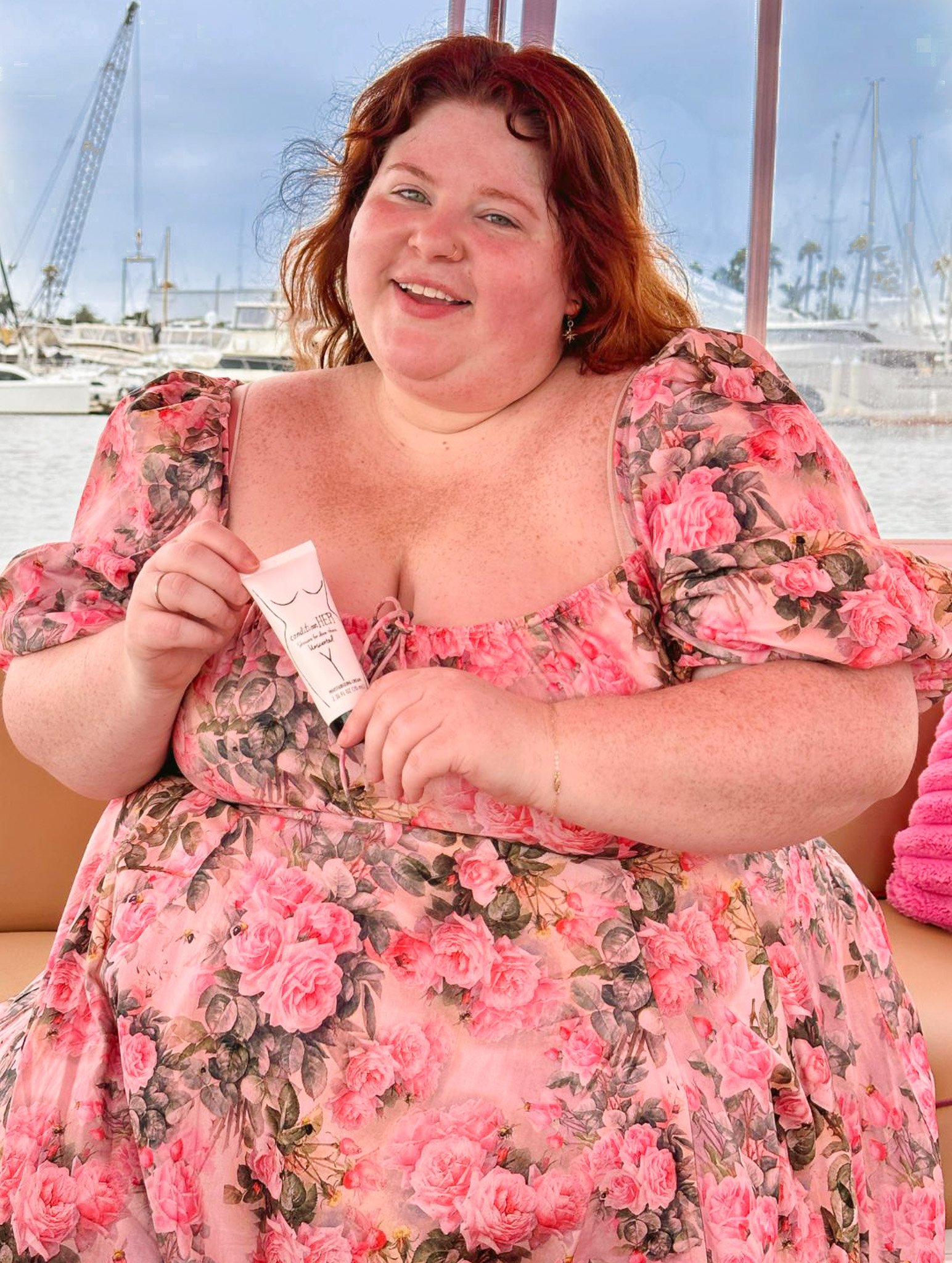 Plus size woman holding a bottle of conditionHER