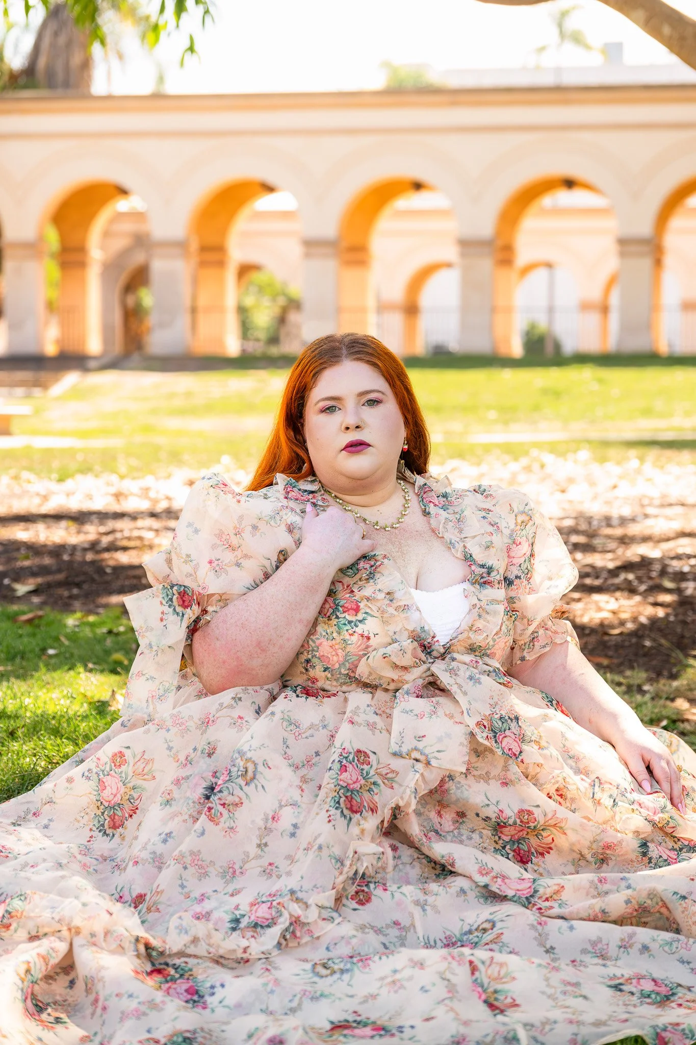 Plus size woman wearing a big poofy gown in the grass