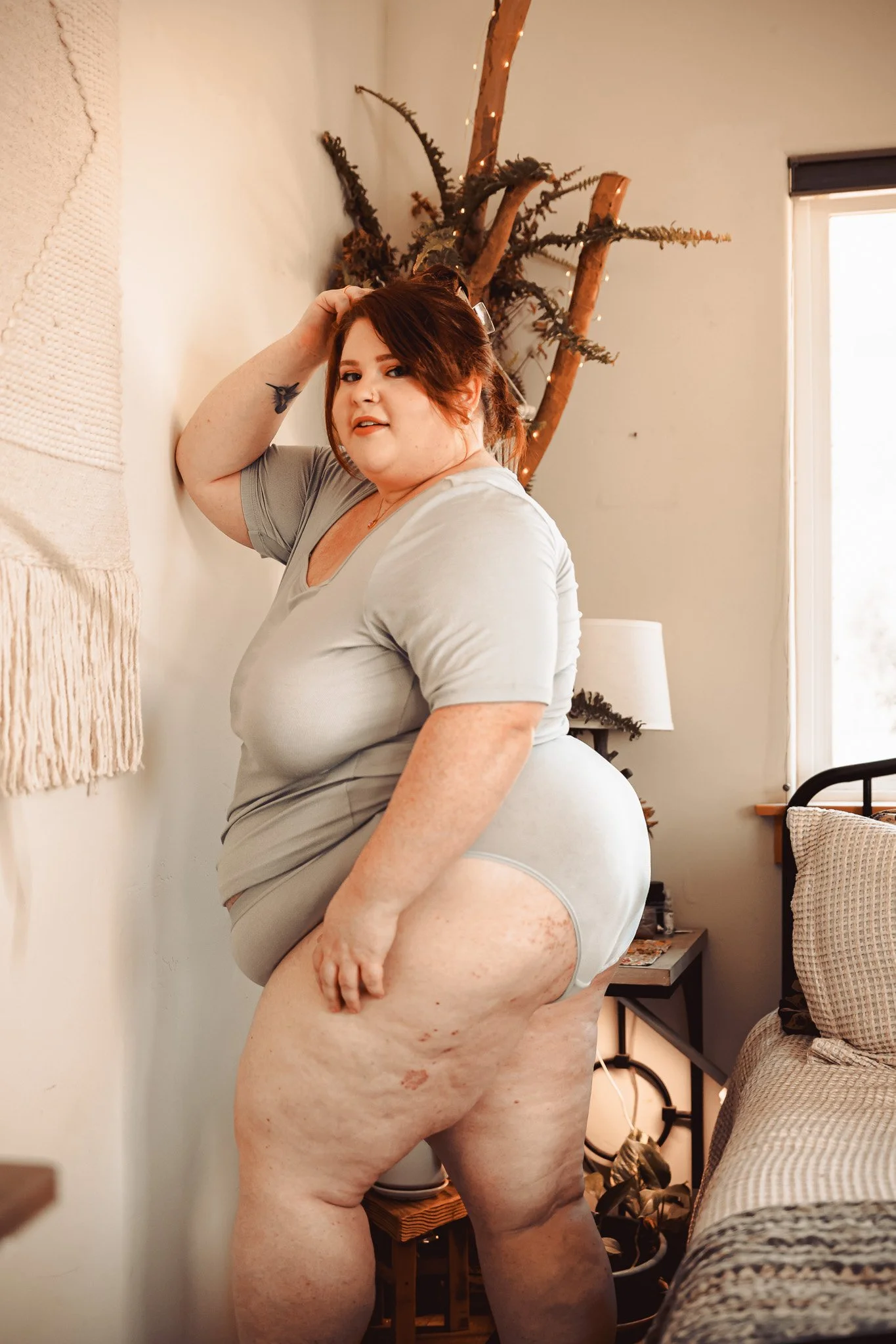 Plus size woman in a shirt and underwear.