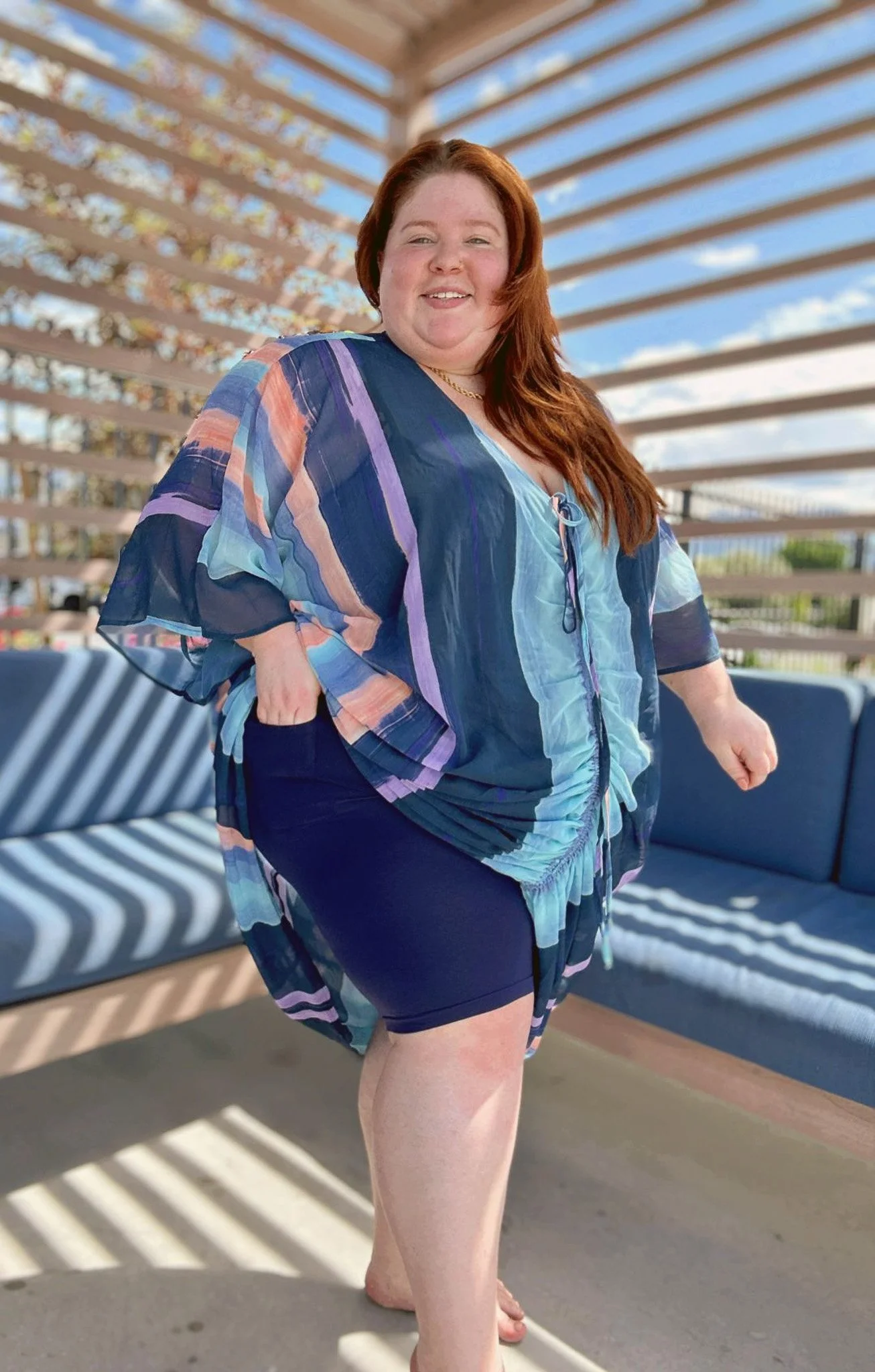 Plus Size woman lifting up her dress to put her hand in a pocket on her anti-chafing shorts