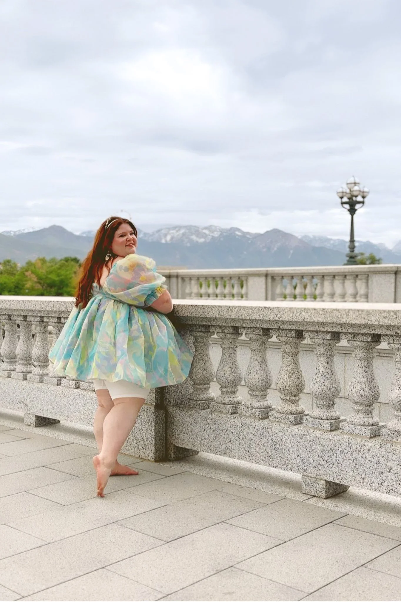 Plus Size woman wearing a short dress that is showing her anti-chafing shorts underneath.