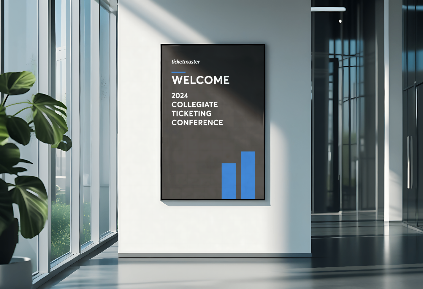 Digital signage in a modern lobby displays welcome message for 2024 Collegiate Ticketing Conference with logo, date, and graphic elements, surrounded by large windows and green plants.