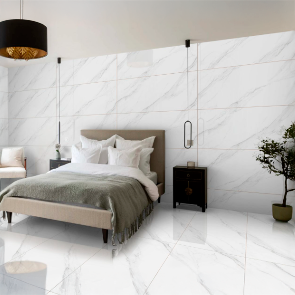 Dormitorio moderno con paredes y piso de mármol, cama con cabecera gris, ropa de cama blanca y mantas grises, lámparas colgantes, mobiliario negro y una planta en una maceta.