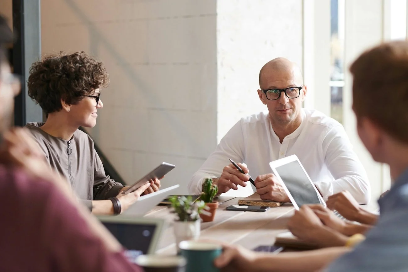 Five-person legal and business strategy meeting — scaling business legal support in Sydney or Melbourne.