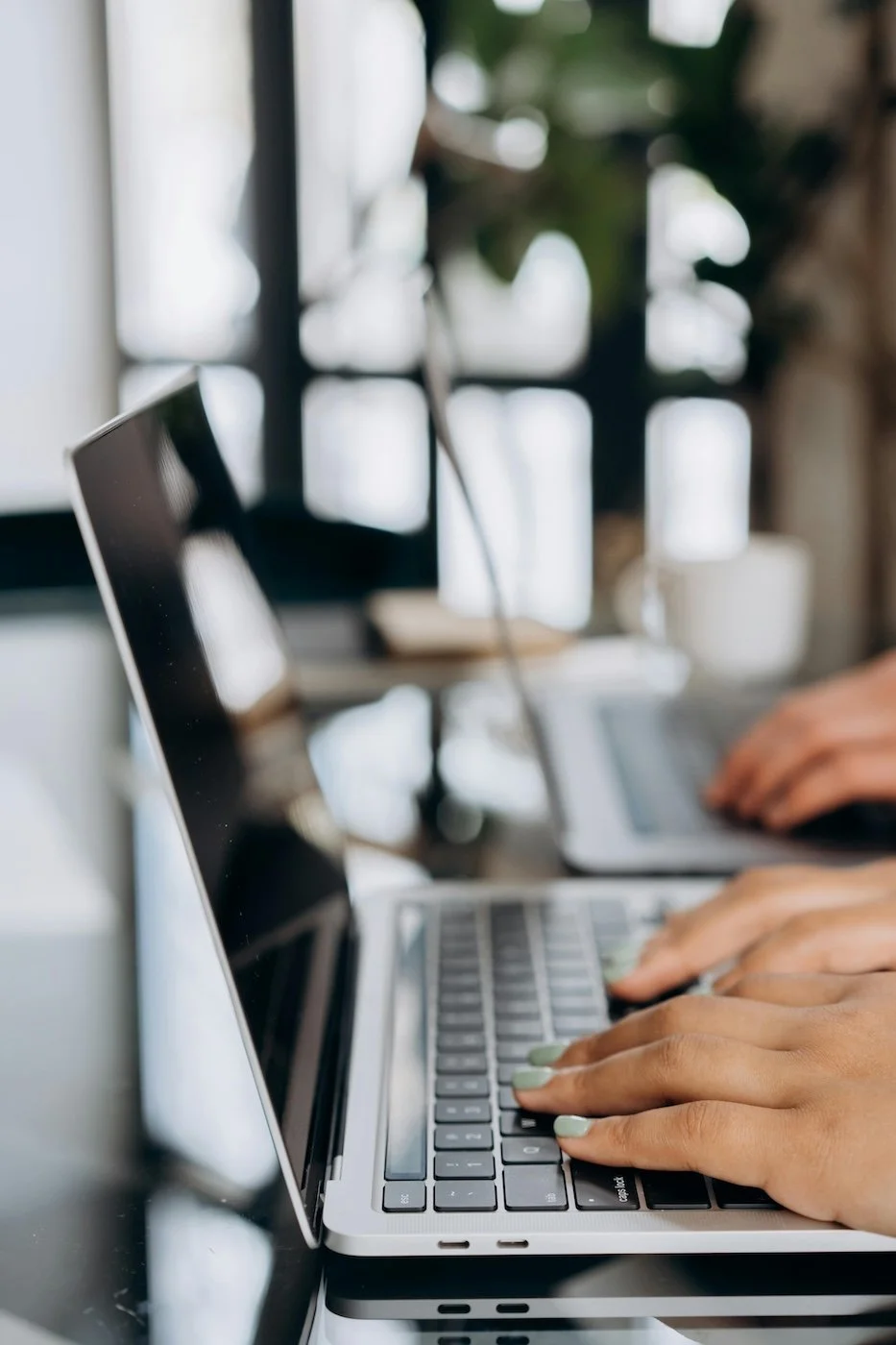 Close-up of hands typing on laptop keyboard — remote legal services for tech startups and digital contract reviews.Calina Popovski, founder of Pixel Legal