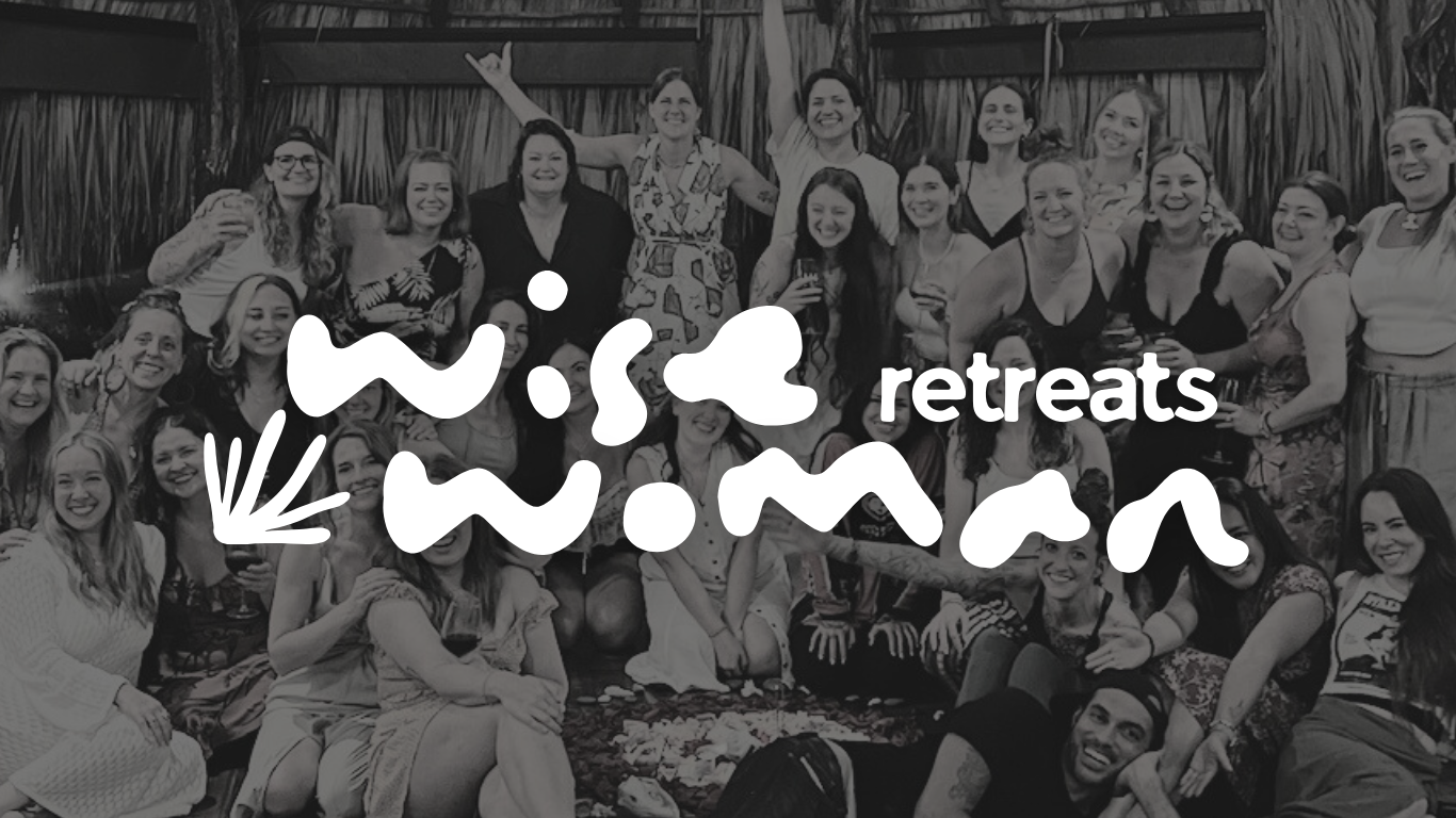 Group of women at a retreat enjoying socializing, some holding drinks, outdoor setting, tropical or beach-themed backdrop, in black and white