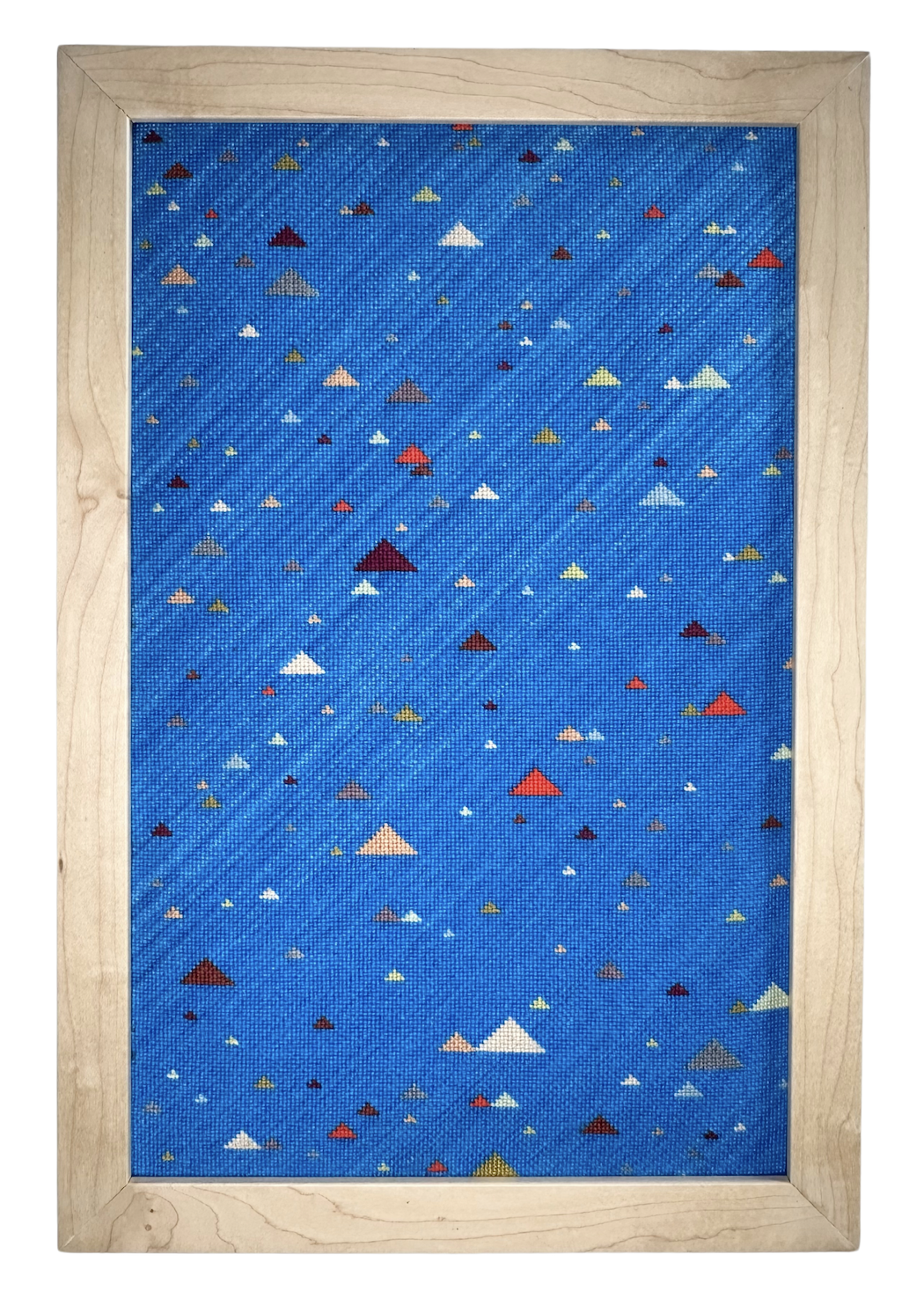 Blue framed artwork featuring numerous small, multicolored triangles of various sizes scattered across the surface.