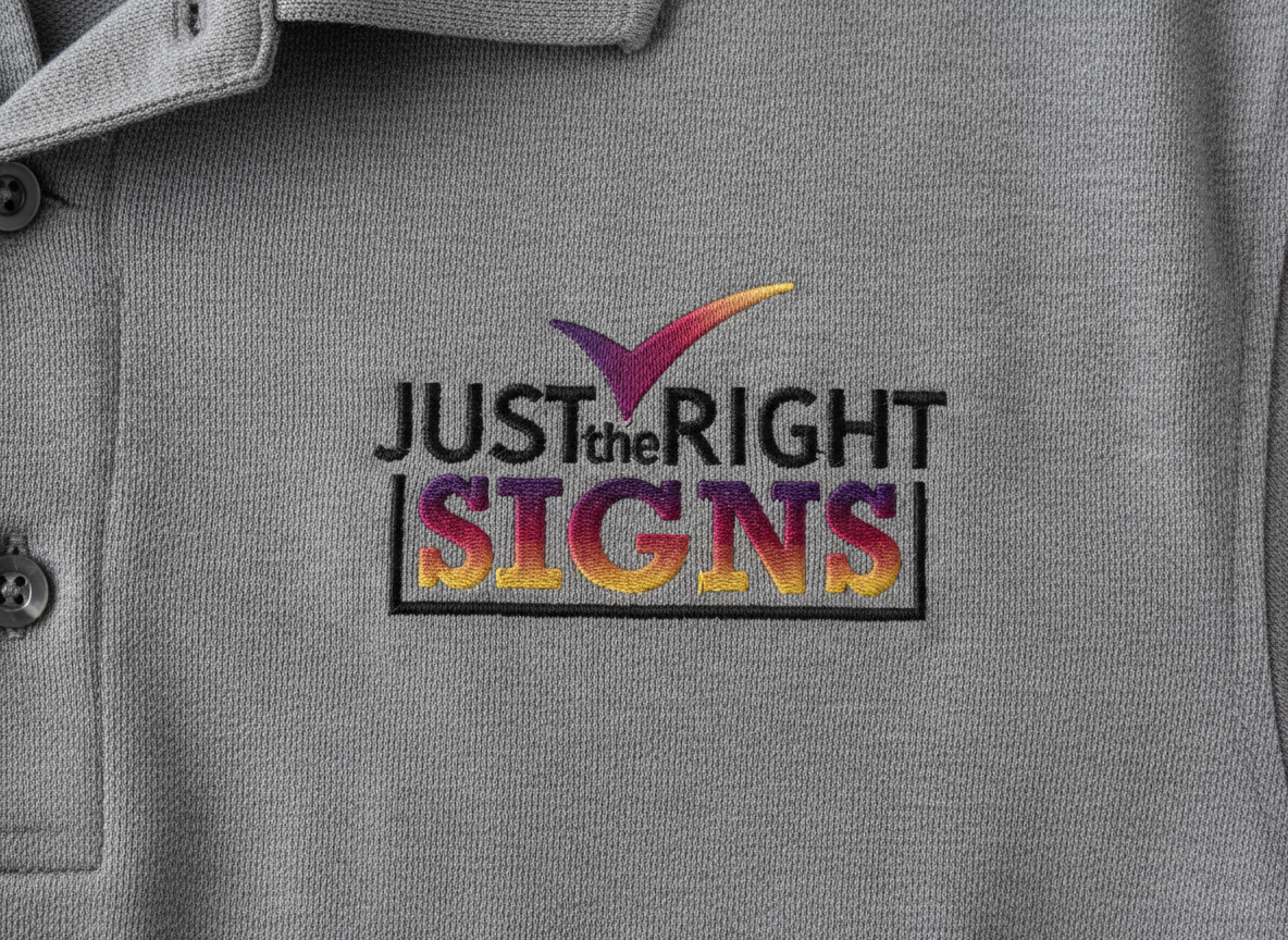 Grey polo shirt with embroidered logo reading 'Just the Right Signs' with a colorful check mark above the text.