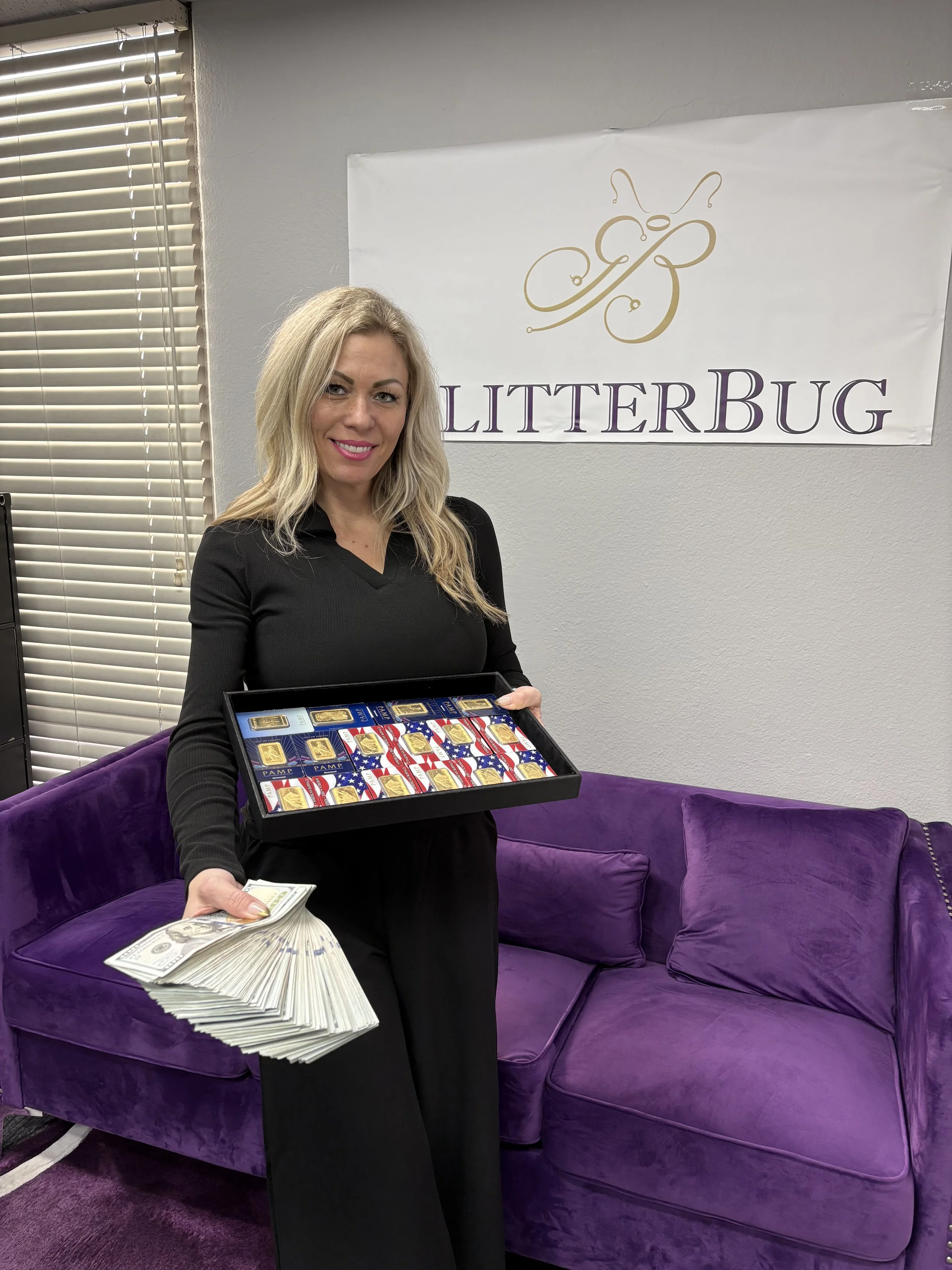 A woman holding a tray of gold bar chocolates and a large stack of hundred-dollar bills in front of a purple velvet sofa, with a 'LITTERBUG' sign on the wall behind her.