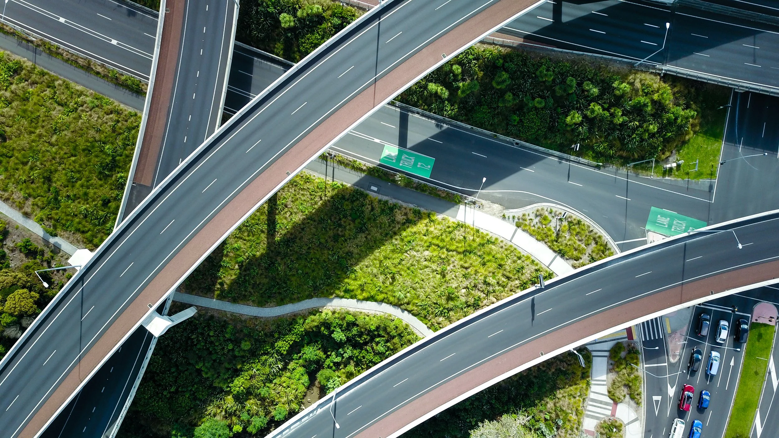 This image shows an aerial view of a highway intersection known as Central Motorway Junction, located in Auckland, New Zealand.