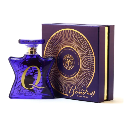 A purple perfume bottle with a gold letter Q and a matching box with gold design, labeled Bond No. 9 Queens in gold and purple.