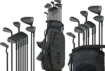 Collection of golf clubs with two golf bags.