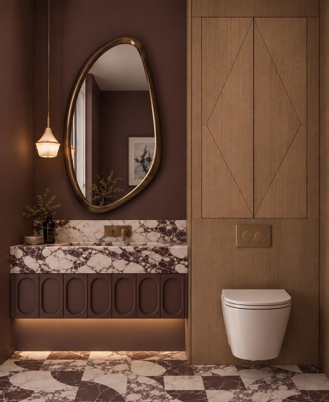 A powder room is one of those spaces where you can afford to be a little more dramatic.

For this one, we leaned into rich burgundy tones, expressive stone, warm wood and aged brass, creating a space that feels intimate, layered and a little unexpect