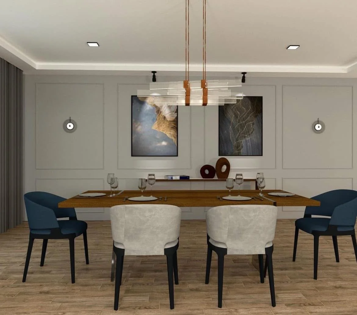 Modern dining room with a wooden table set with six glasses and white plates, six chairs in navy blue and cream, artwork and decor on the wall, and a geometric chandelier hanging from the ceiling.
