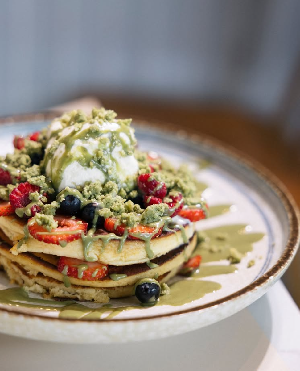 Oyku Pistachio Cream Sauce drizzled over pancakes with strawberries, blueberries, crumble and ice cream at Leaf Café