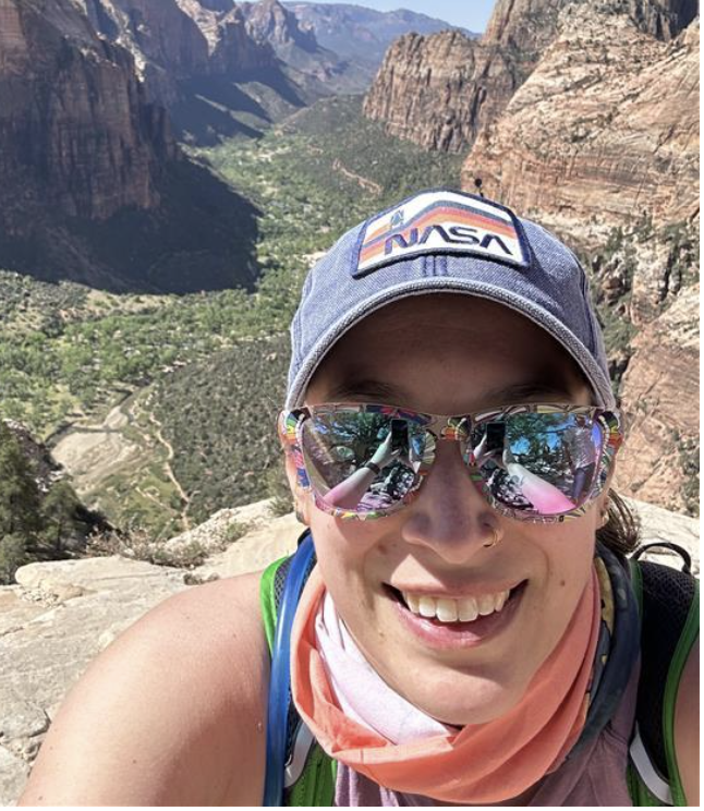 LEILANI PRUSKI, SMILING IN A MOUNTAIN CANYON