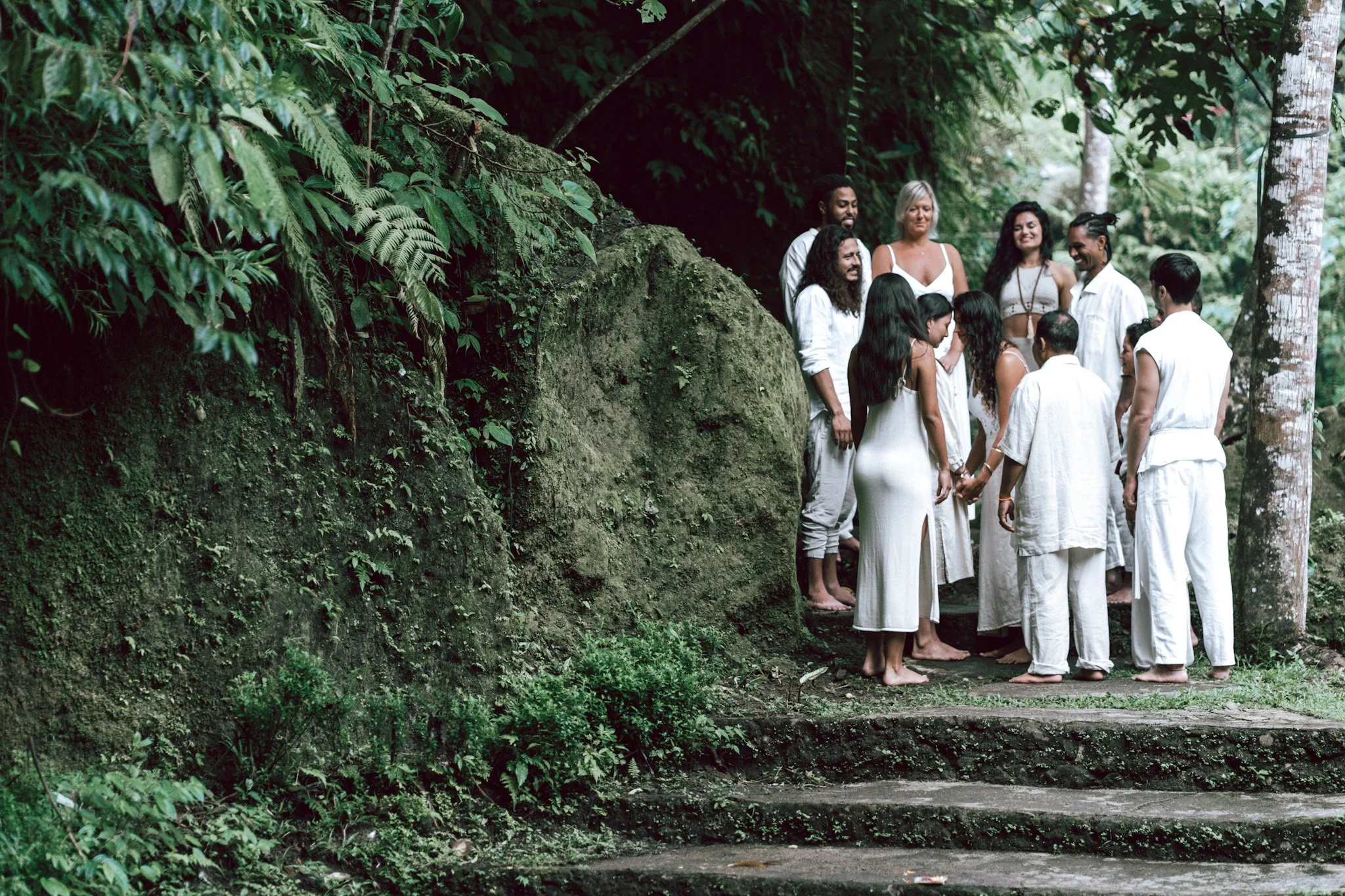 a group of people standing on the side of a rock celebrating