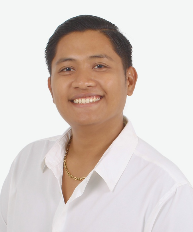 A man looking straight to the camera while slightly leaning