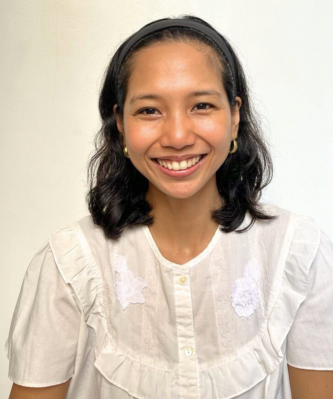 a woman facing the camera while smiling