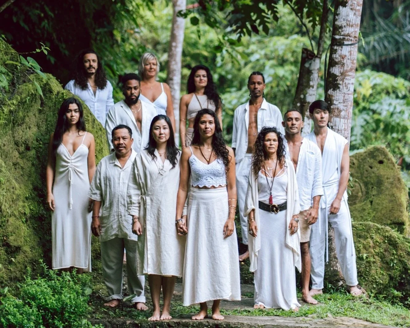 a group of people standing barefoot in nature while looking at the camera