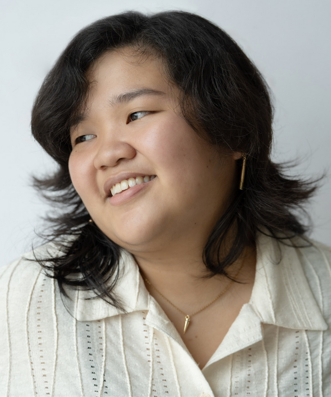 a woman looking to the side while smiling