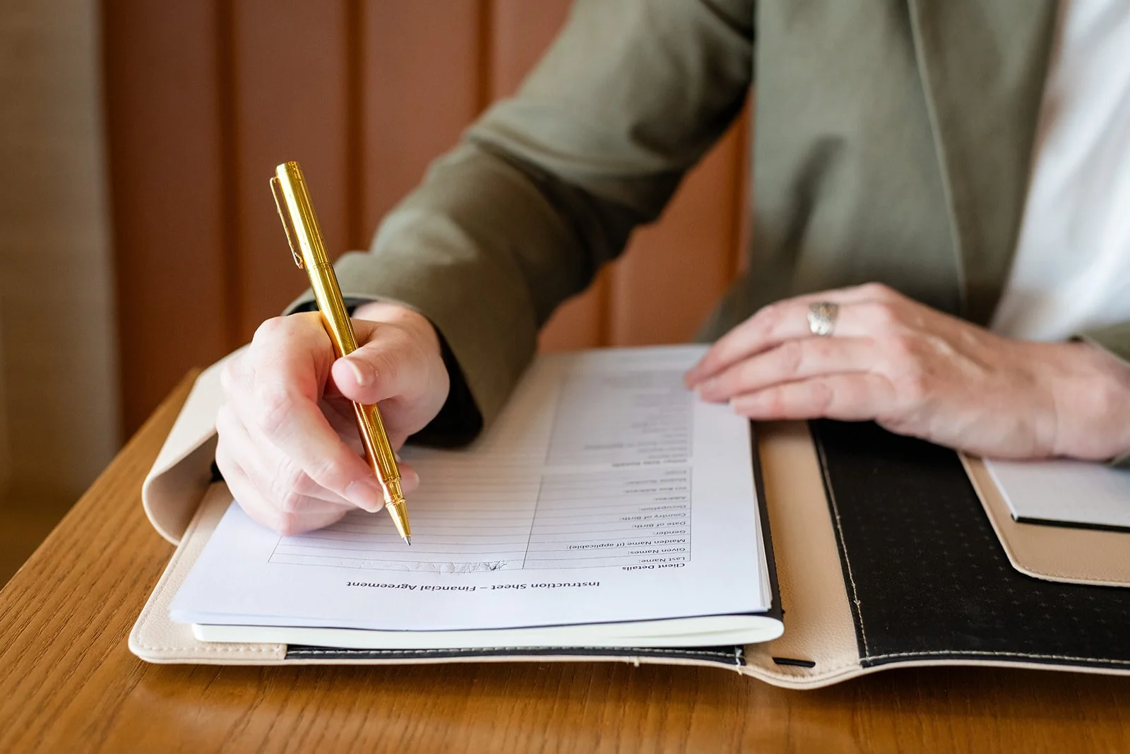 hands writing in a Principal Agreement form