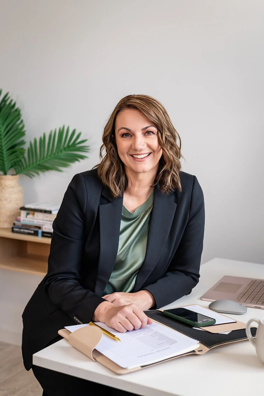 Sarah sitting at desk with paperwork