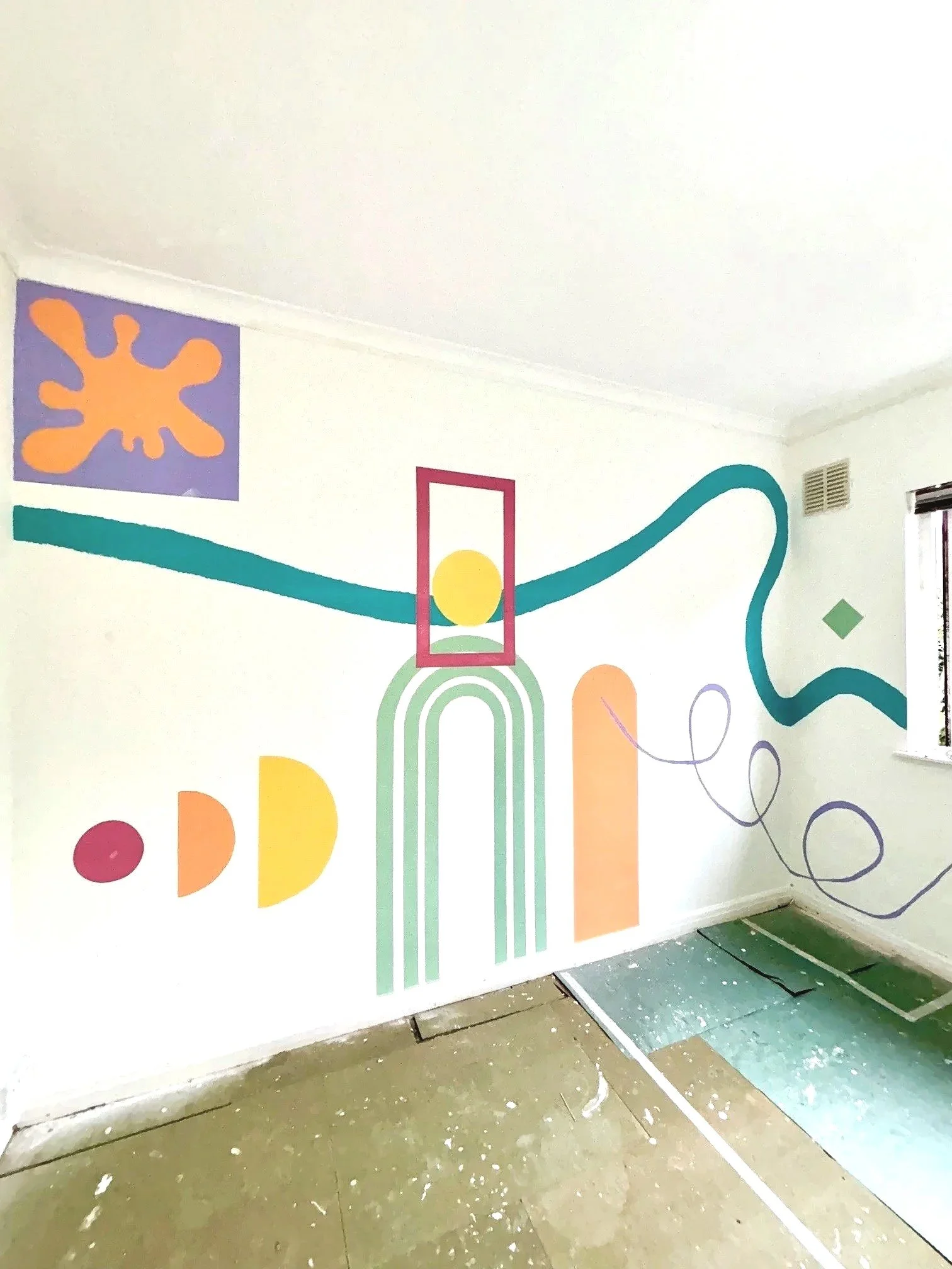Abstract geometric mural featuring arches, circles, and flowing lines in teal, orange, yellow, purple, and green. Hand painted. ideal for community spaces, bedrooms, bold art inspiration. fun wall art. Hertfordshire based artist. uk wide murals. teen