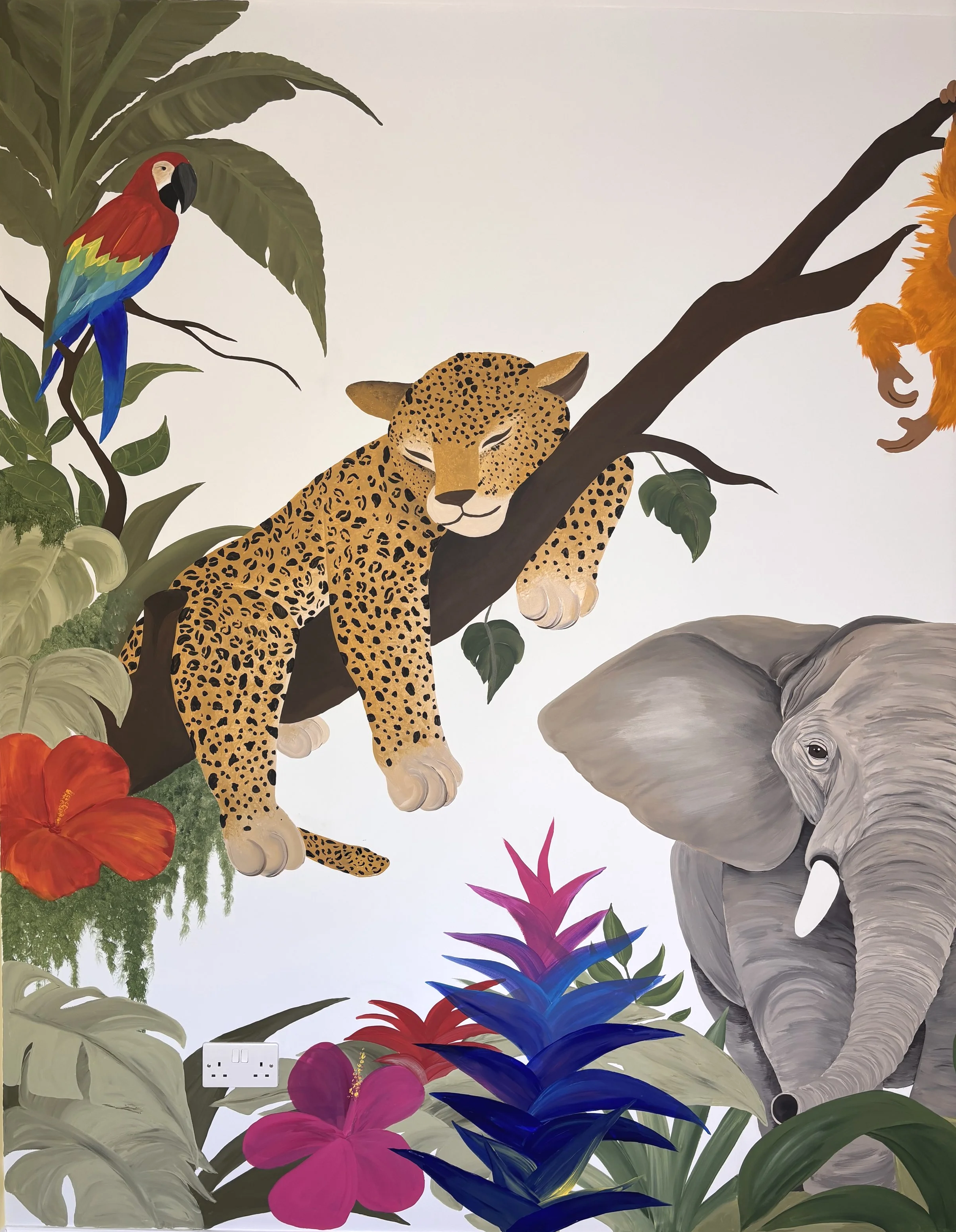 bespoke hand painted jungle safari mural featuring exotic animals, tropical leaves and vibrant natural elements. designed to inspire imagination and adventure, this custom mural creates a striking feature wall for nurseries childrens bedrooms schools