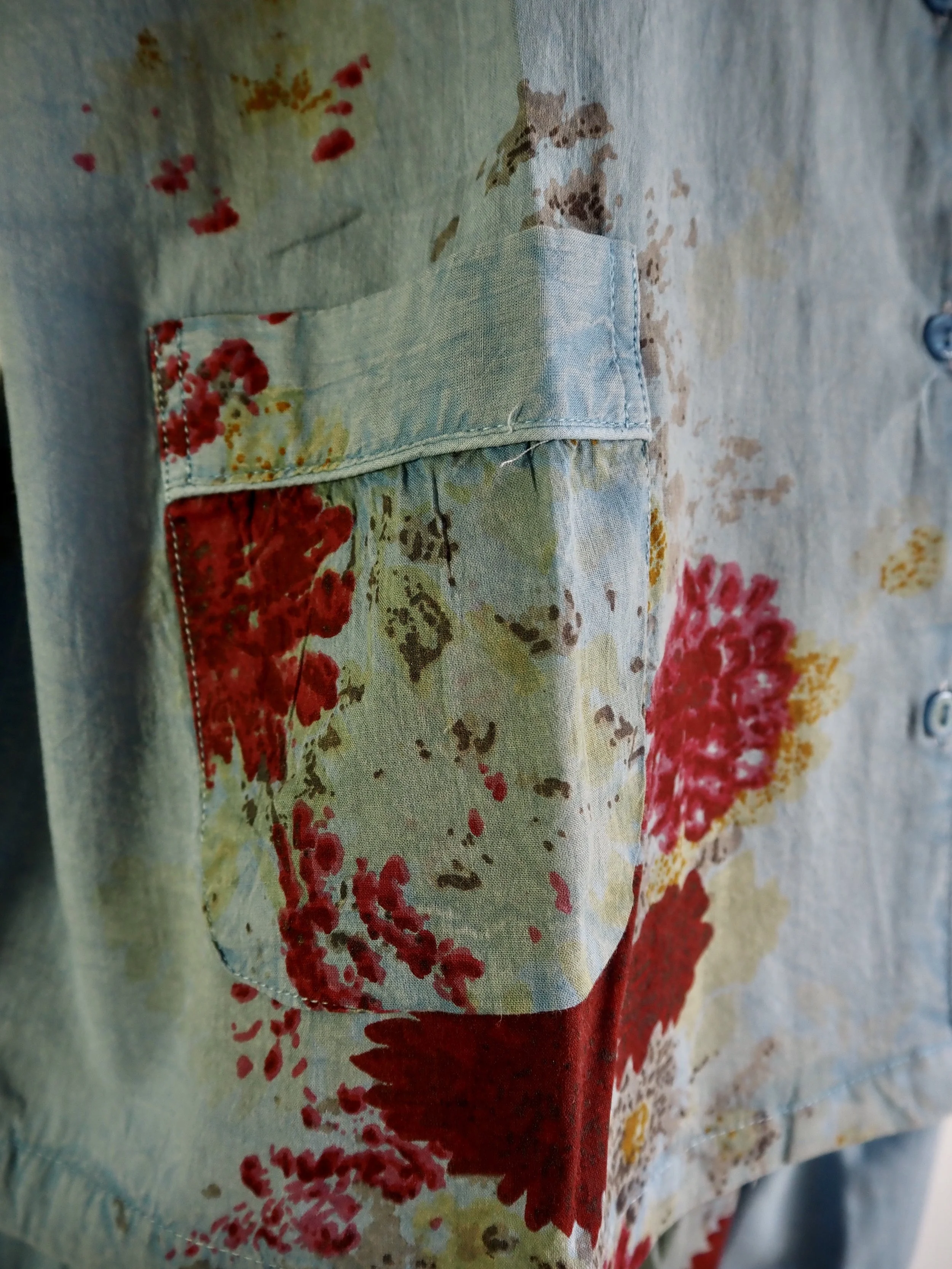 Close-up of a floral-patterned shirt with a matching pocket and button details